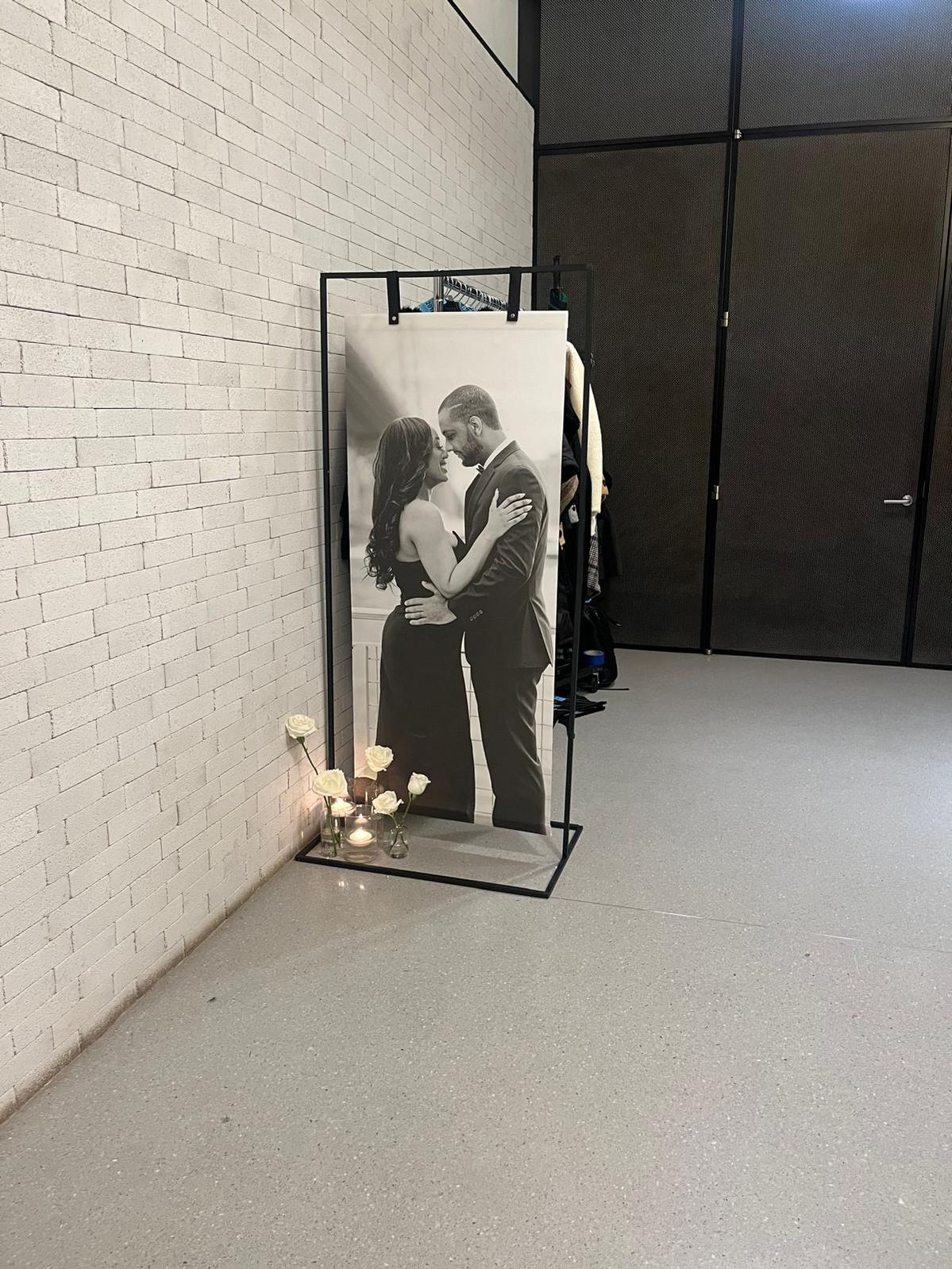 a black and white photo of a man and woman kissing