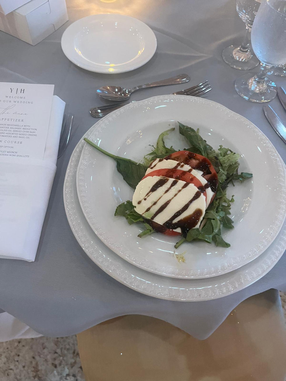 a plate of food with a menu behind it that says " welcome your wedding "