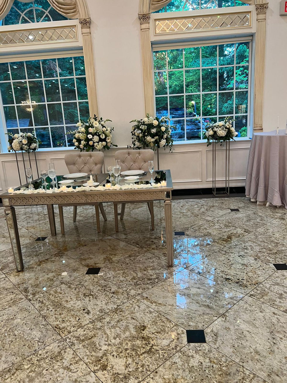 the bride and groom 's table is decorated with flowers and candles