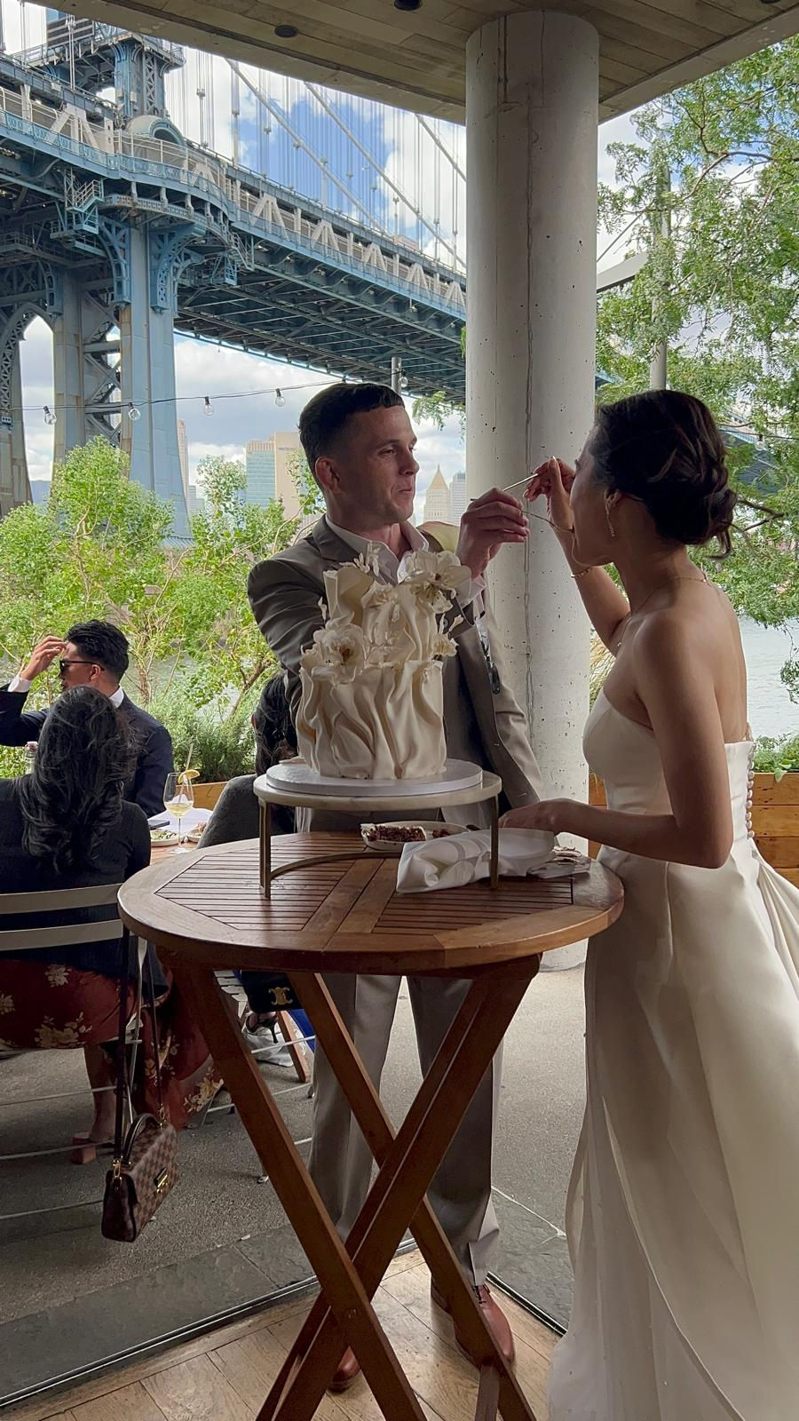 a bride and groom are cutting their wedding cake