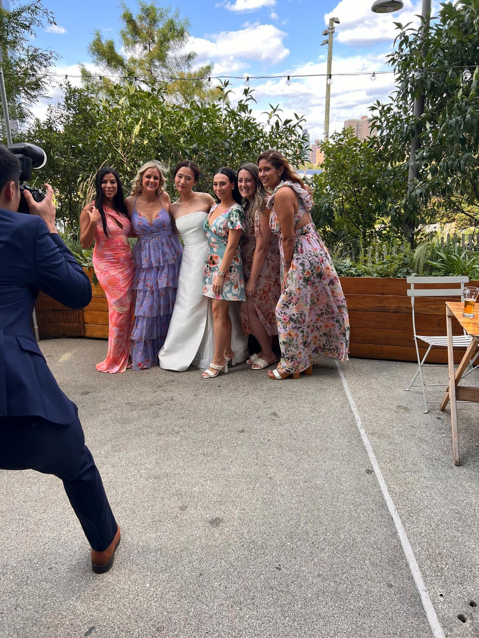 a man is taking a picture of a bride and her bridesmaids