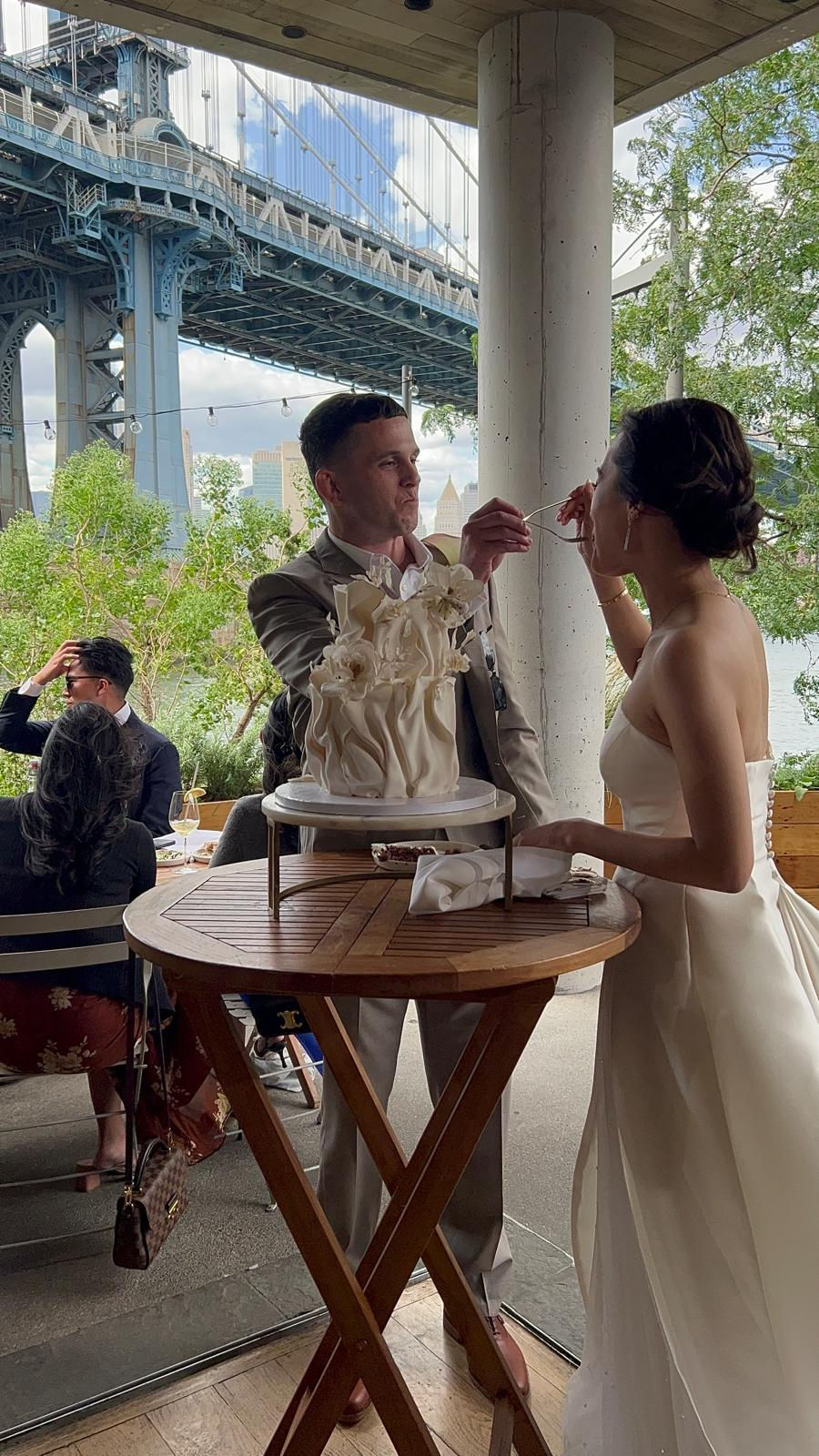 a bride and groom are cutting their wedding cake
