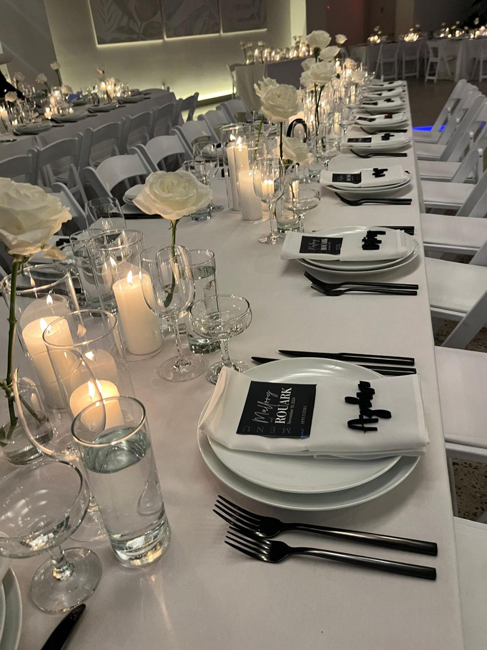 a long white table set for a wedding reception
