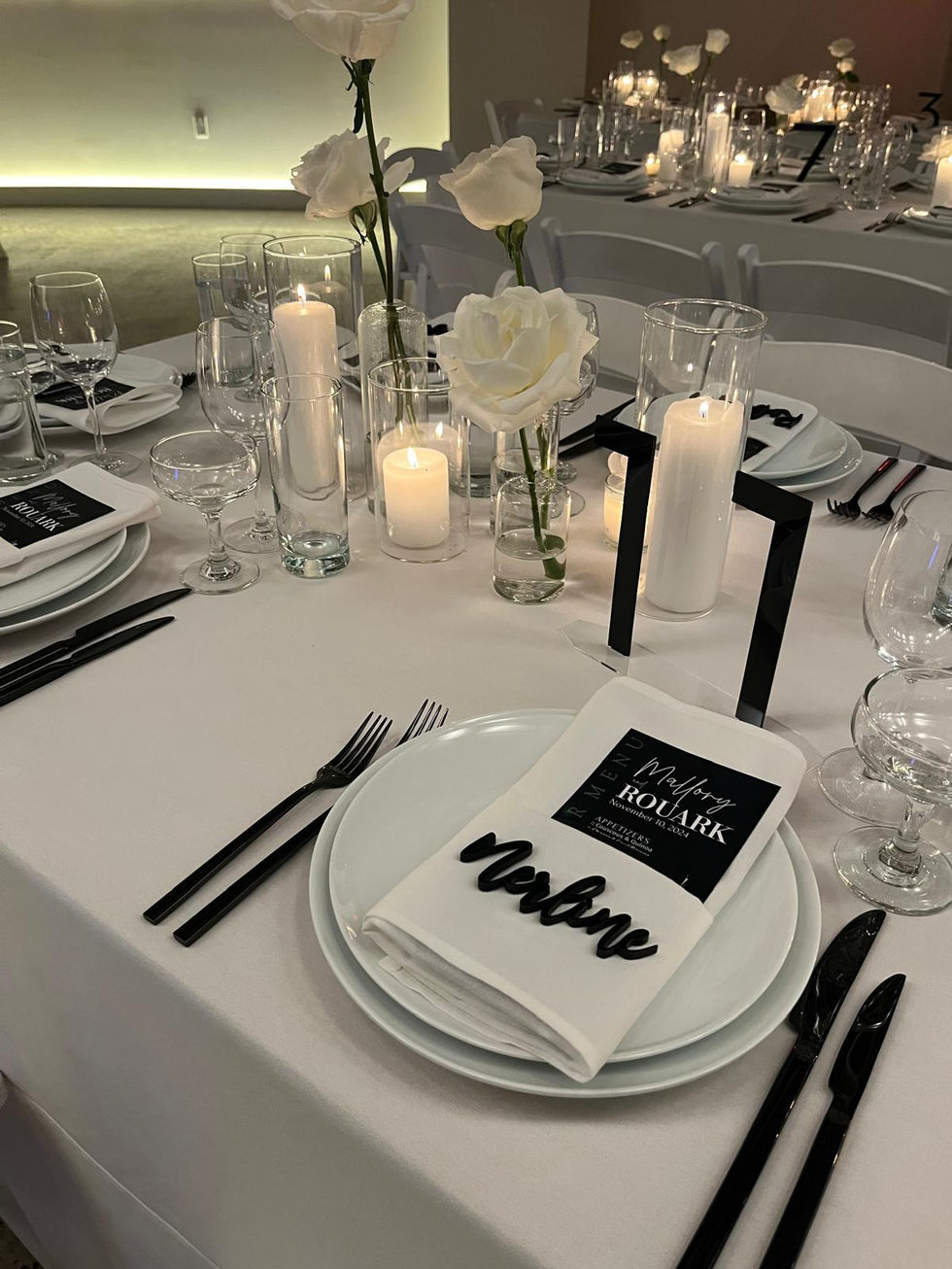 a place setting for a wedding reception with plates and candles