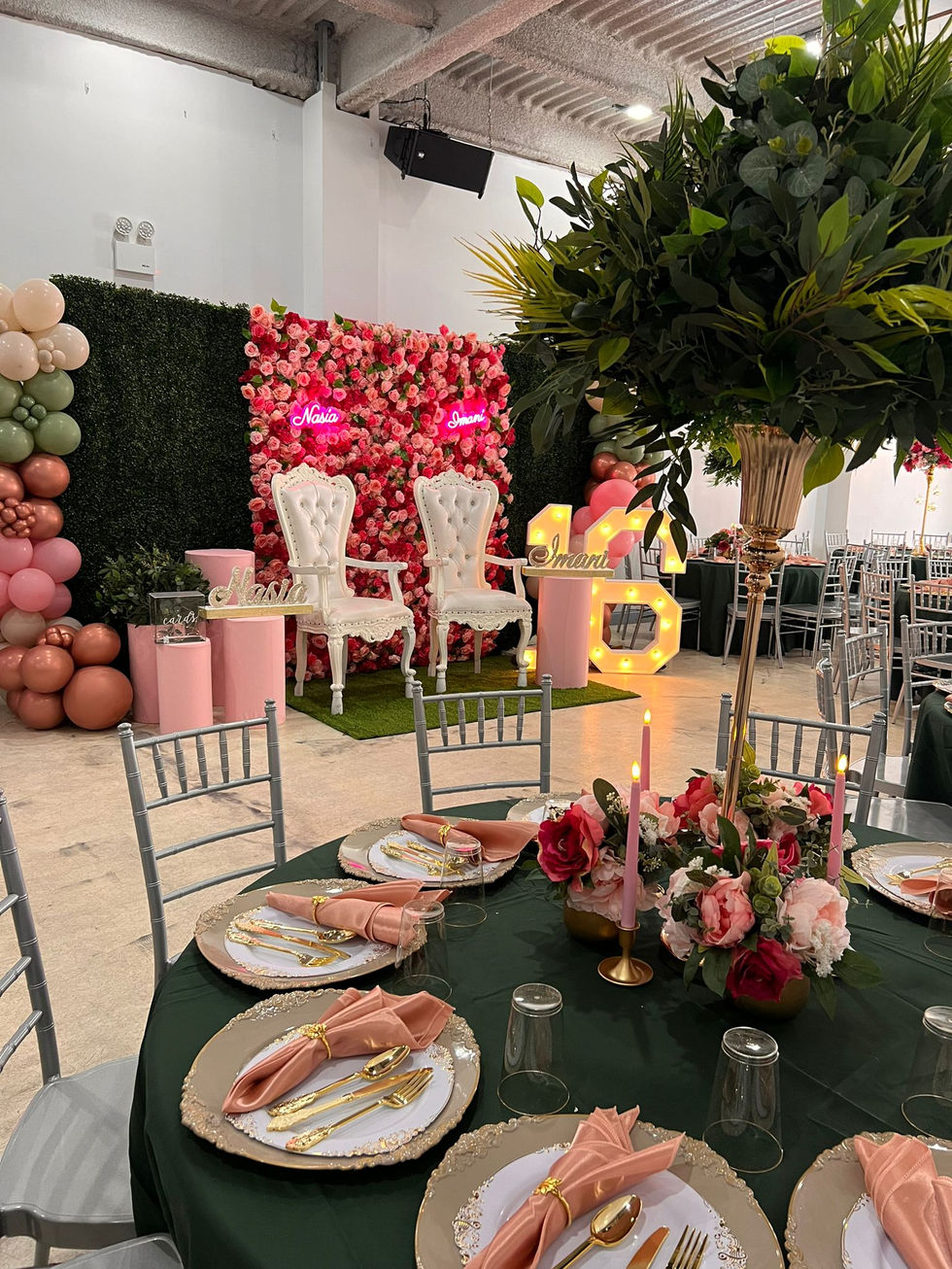 a table set up for a party with flowers and candles