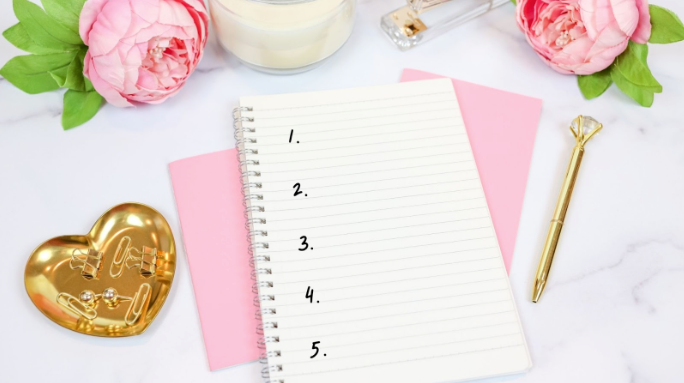 A pen and paper representing a list of website homepage design rules.