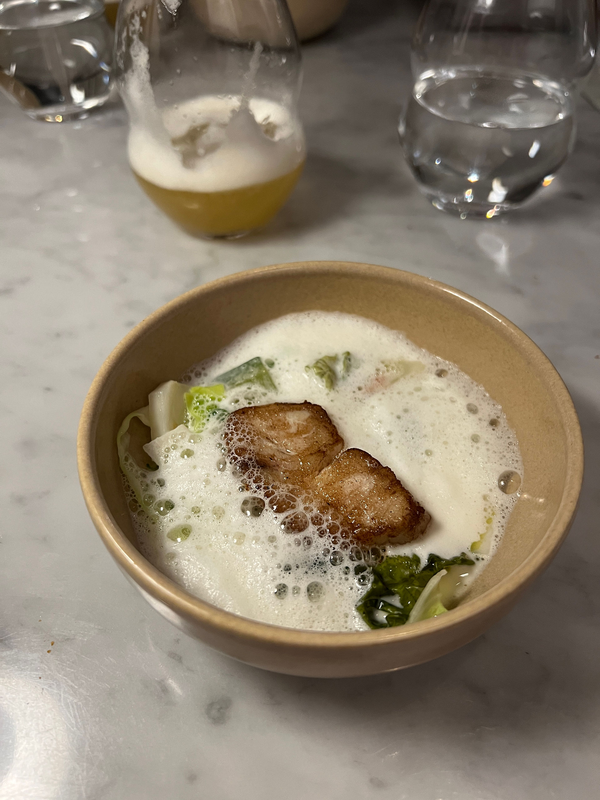 A piece of hake in creamy sauce