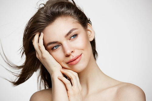beautiful-naked-young-woman-with-perfect-clean-skin-smiling-touching-hair-white-wall-facia