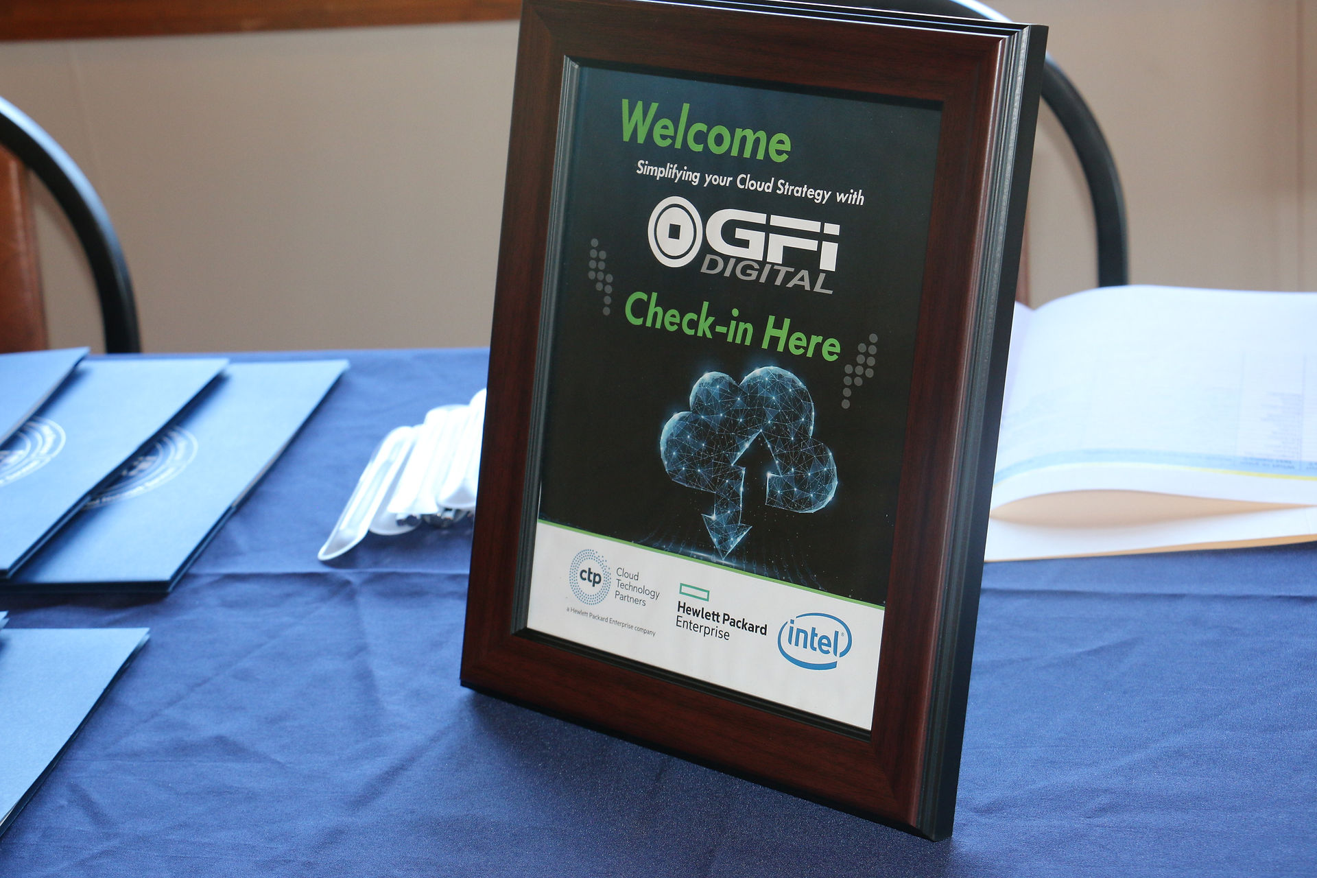 Welcome sign reads 'GFI Cloud'. Check-in here. Cloud technology event.