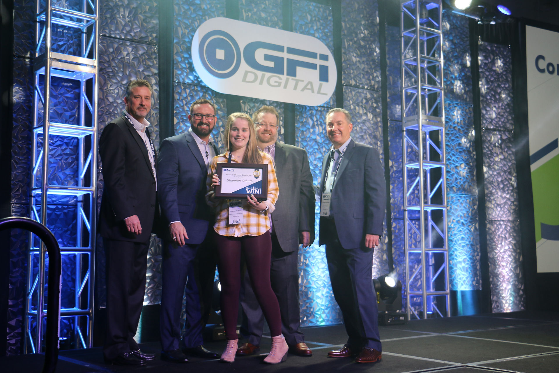 Group photo at GFI Digital event with award, text visible