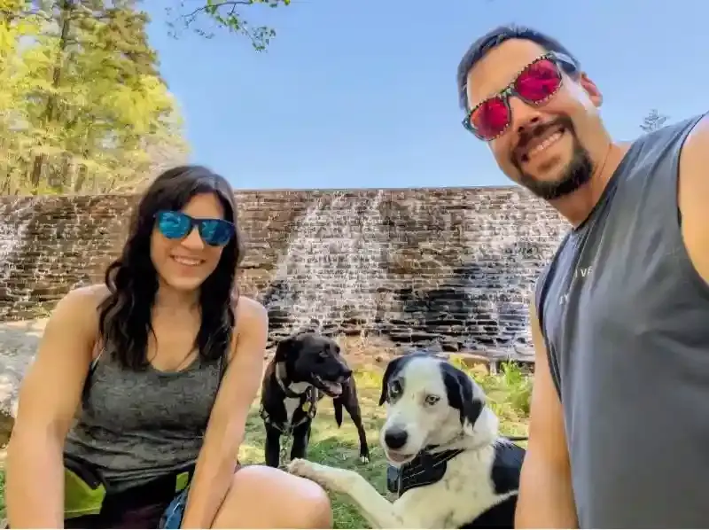 Rachel Dewitt with her two dogs and an unnamed man