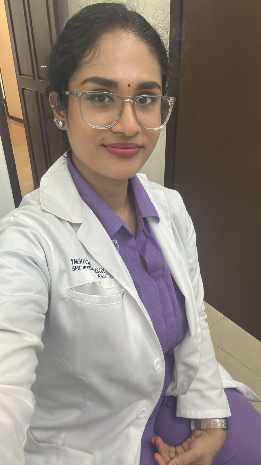 A doctor in a white coat, standing confidently.