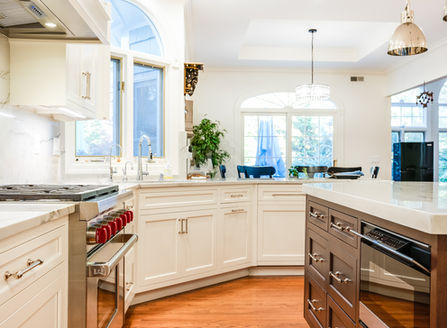 Sink at an angle in 36 inch sink base and dishwasher with wood panel to match cabinetry.