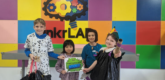Children wearing garments made from recycled materials.