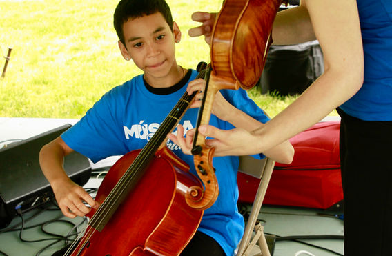 Música Franklin cellist and teacher work on a bassline together.jpeg