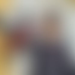 Boy in front of a lifesize statute of a cow.