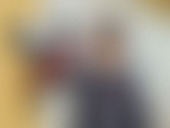 Boy in front of a lifesize statute of a cow.