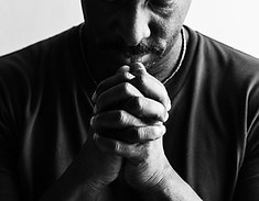 African American man resting his chin on