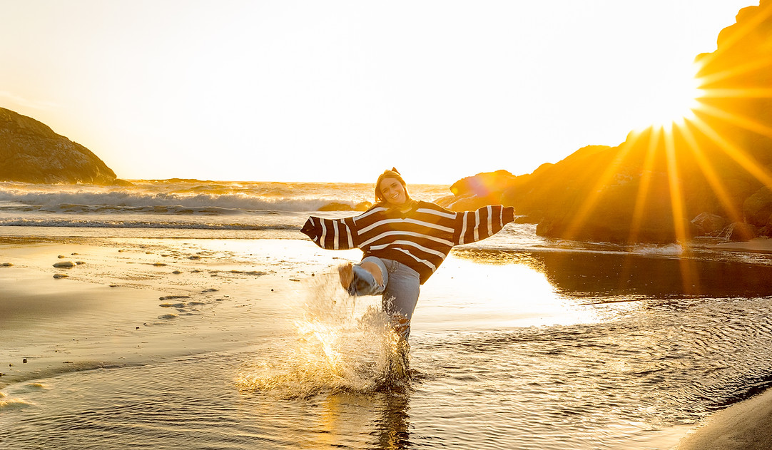 High School Senior celebrating in the Oregon Coast waters.
