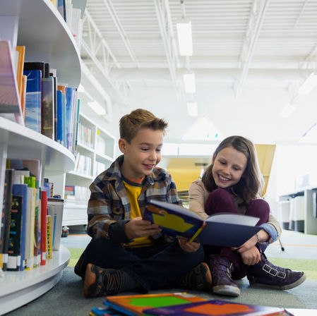 δύο παιδιά που διαβάζουν σε σχολική βιβλιοθήκη
