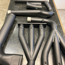 Full exhaust system from a Lister coated in black Cerakote