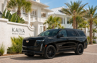 Elevate's Cadillac Escalade ESV parked inside of Kaiya Beach Resort on 30A