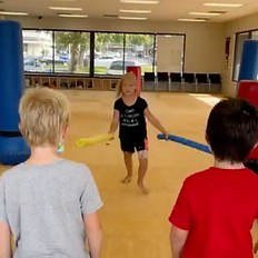 Children playing martial arts games at summer camp