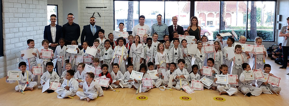 Top Stars Martial Arts students with instructors holding up certificates.