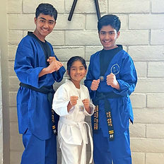 Three martial arts students in uniforms