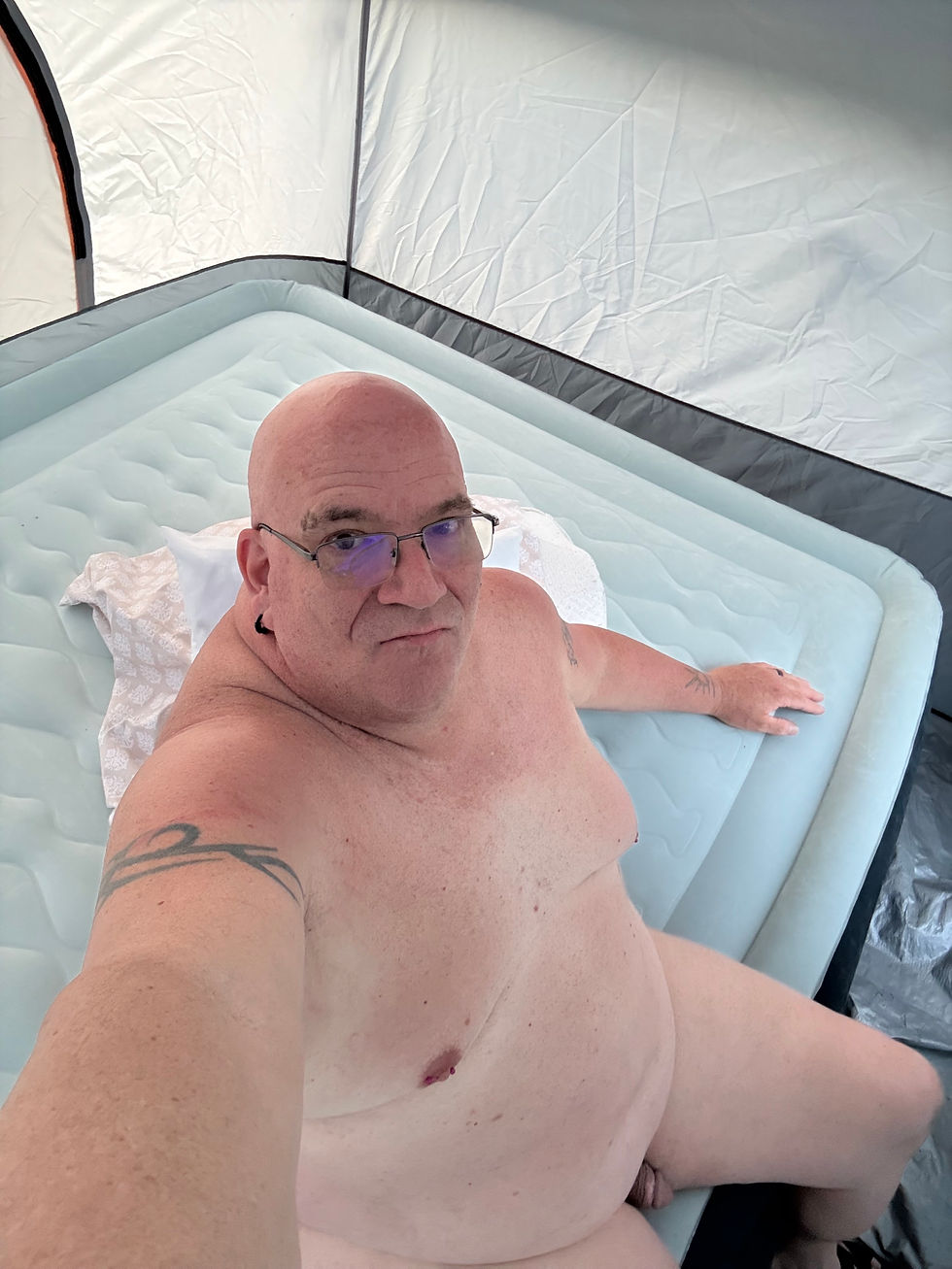 Aerial view of vibrant festival grounds with colorful tents and stages