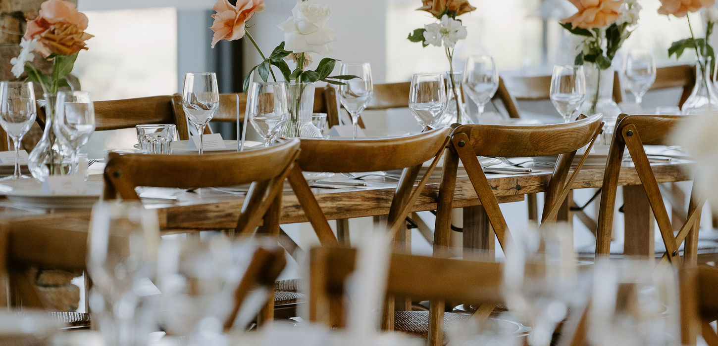 Close-up of table decor with greenery and glassware at Kangaroo Valley Bush Retreat wedding.