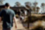 Guests walking along boardwalk past accommodation buildings at KVBR.