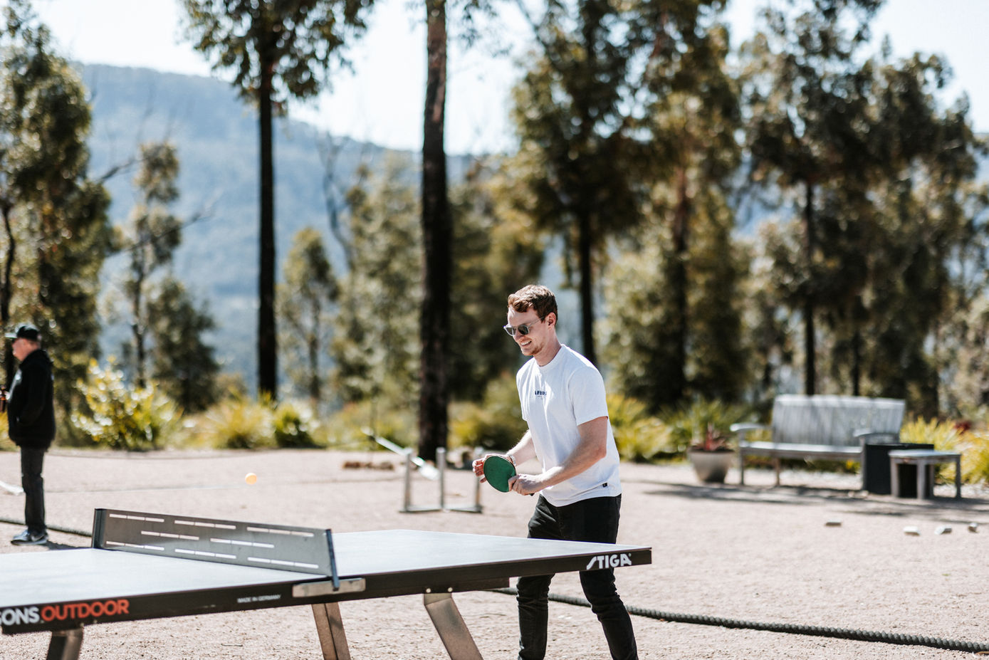 Guest playing table tennis outdoors in the Games Area at KVBR.