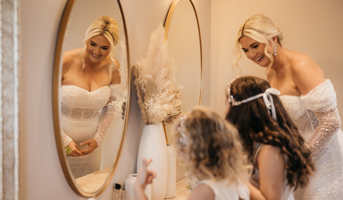 Bridesmaids helping the bride with her dress in the Bridal Suite.