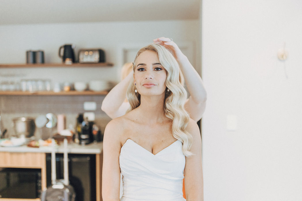 Final styling to the brides hairstyle.