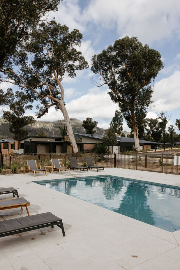 KVBR poolside with sun loungers and trees in the background.