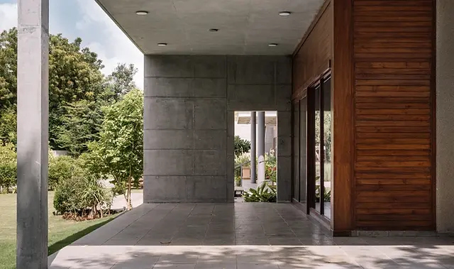 Exterior details of the house showing the juxtaposition of wood-paneling with bare concrete 