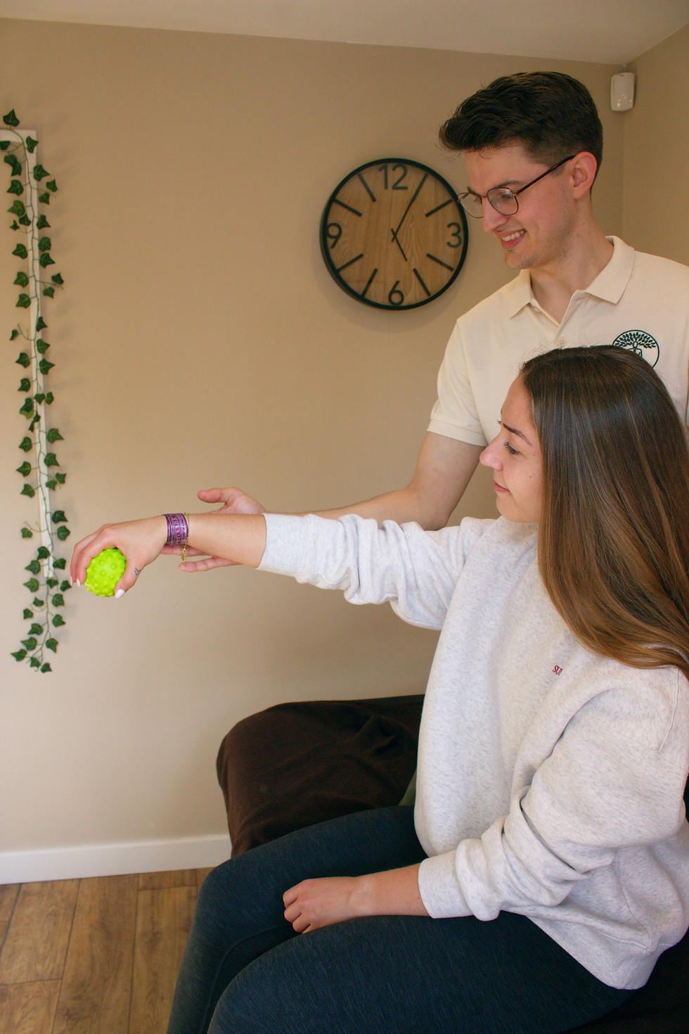 Senior Physiotherapist Max Ankerstjerne assessing a clients wrist.
