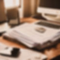 stack of papers and a laptop on a clean desk_edited.jpg