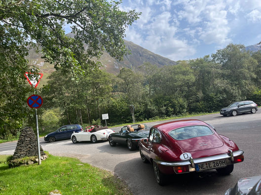 Group of classic cars in the Scottish Highlands