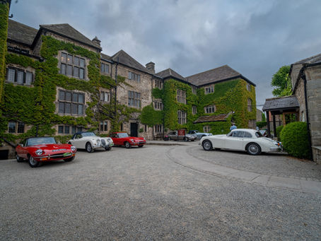 Jaguar XKs and E-types parked outside the Headlam Hall hotel