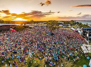 Crowds of people gathering at the Sandstone Point Hotel Concert with Sunset in the background.  