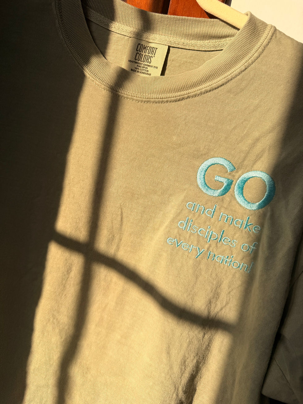 Thumbnail: Comfort color tee with the words “GO and make disciples.” Great Commission Comfort Color Tee