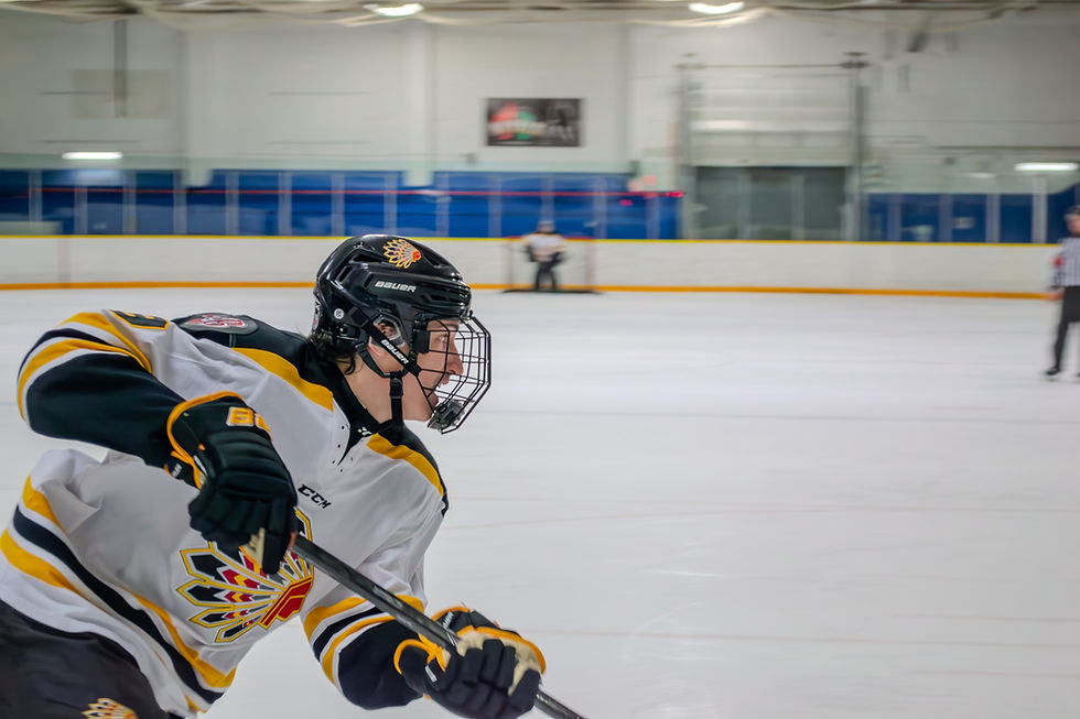 Chiefs player streaking across the ice from the left, blurred surroundings giving a sense of speed.
