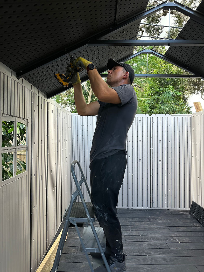 A man with a drill is fixing a garage