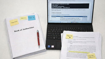 Legal court document PDF with page numbers, bookmarks, and printed tabs prepared for production