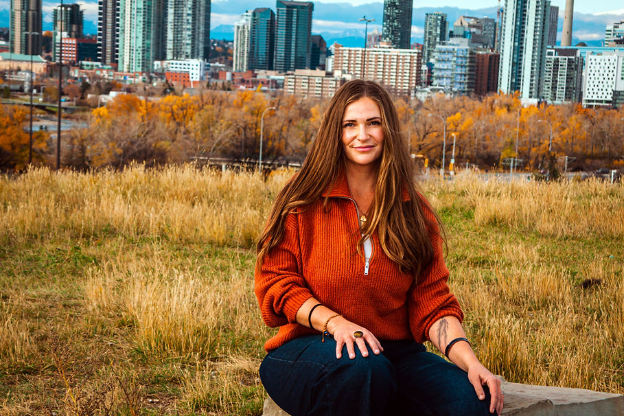 Eva's head shot with fall colours and city scape in the background