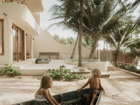 A girl and a boy playing with a boat at Zorba Tulum