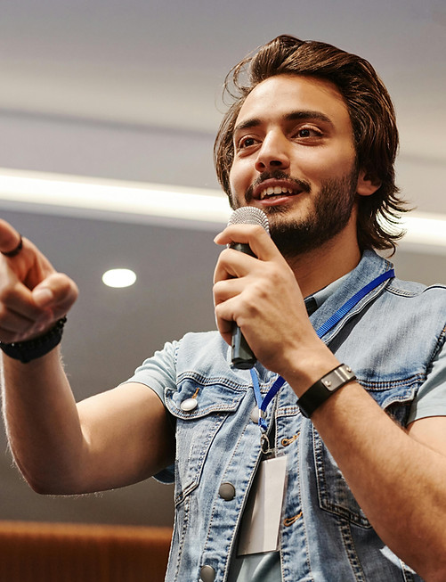 Corporate emcee energizing a team-building activity, encouraging participation from all attendees.