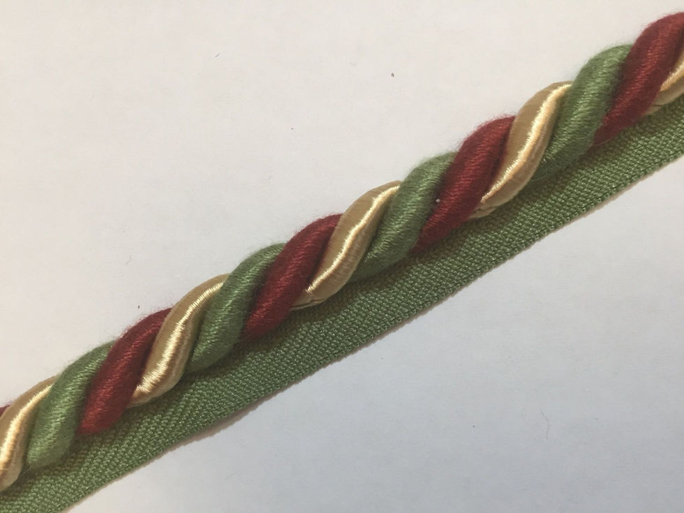 intertwining red, green, and gold lip cord